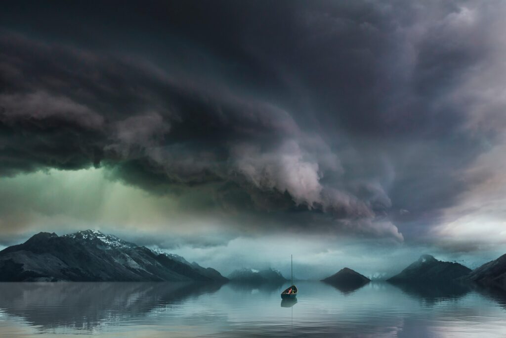 Stormy skies and a sailboat